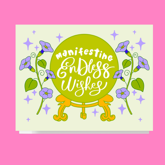 Magical greeting card design featuring a crystal ball illustration and morning glory flowers with the phrase Manifesting Endless Wishes hand lettered inside 